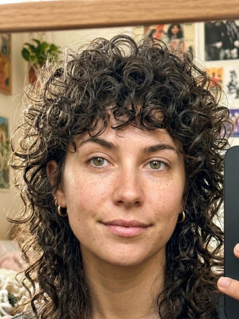7 Mullet Wolf Cut Ideas for Women That Are Trending Right Now 4 Woman taking iPhone selfie 202606202355